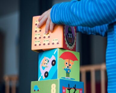 child building an four boxes